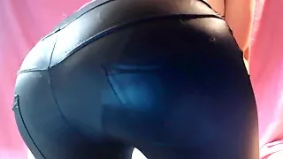 Cute girl in geek glasses farting in tight leather pants