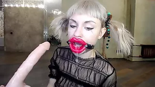 Russian girl fucks herself in the throat with a rubber dick